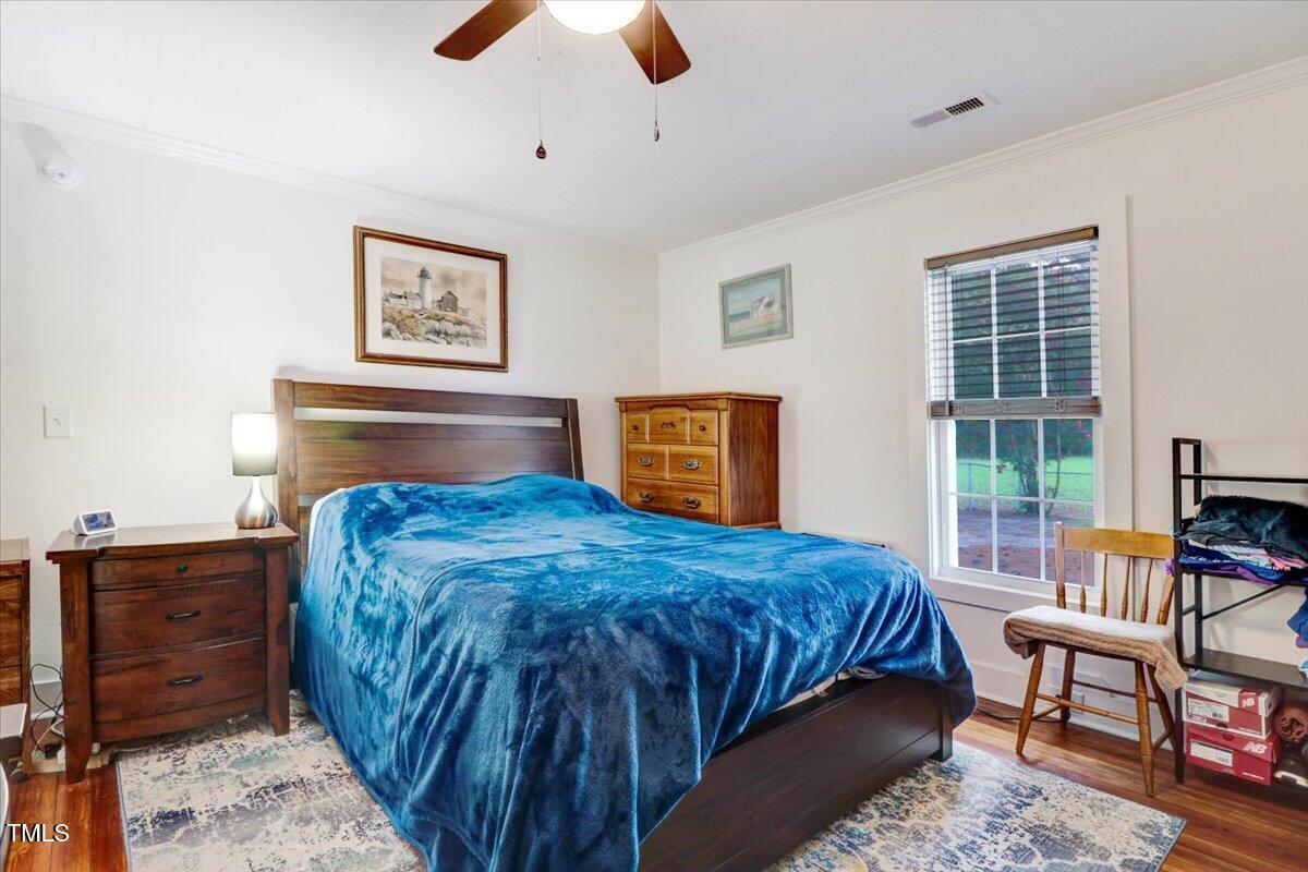 175 Debro Road Kenly, NC 27542 - Photo 19 of 30 a bedroom with bed and large windows