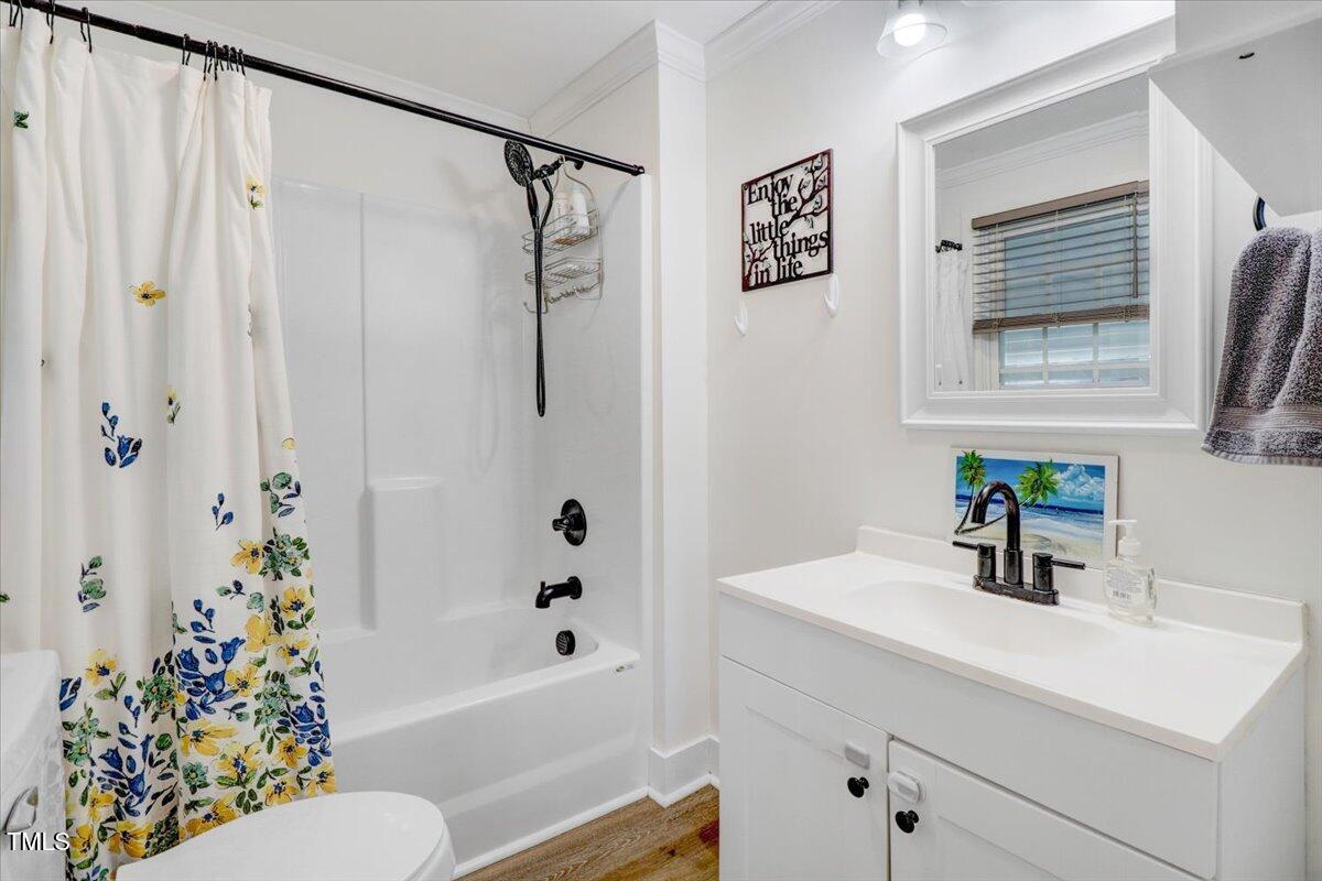 175 Debro Road Kenly, NC 27542 - Photo 21 of 30 a bathroom with a sink a toilet and shower