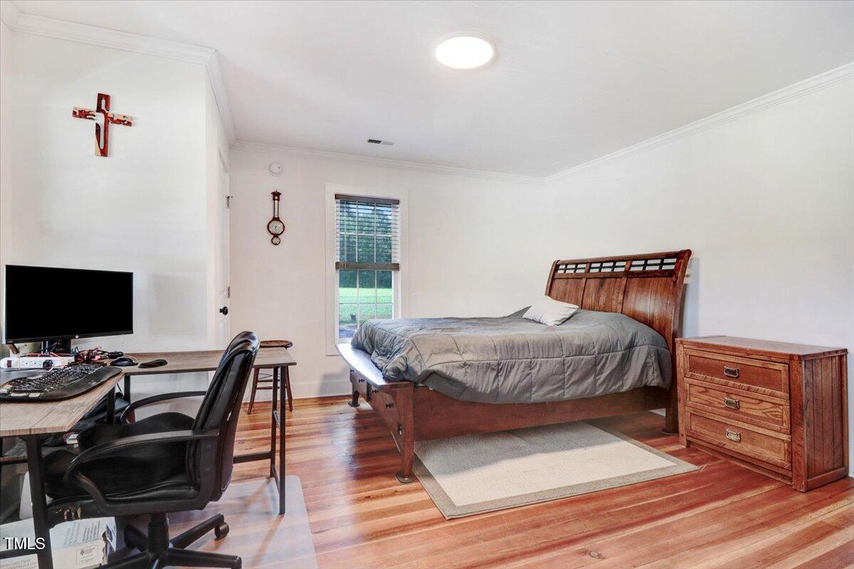 175 Debro Road Kenly, NC 27542 - Photo 22 of 30 a bedroom with a bed and a desk