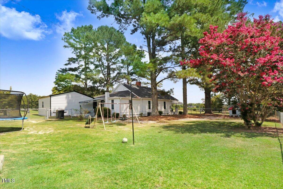 175 Debro Road Kenly, NC 27542 - Photo 26 of 30 a house with swimming pool in front of it