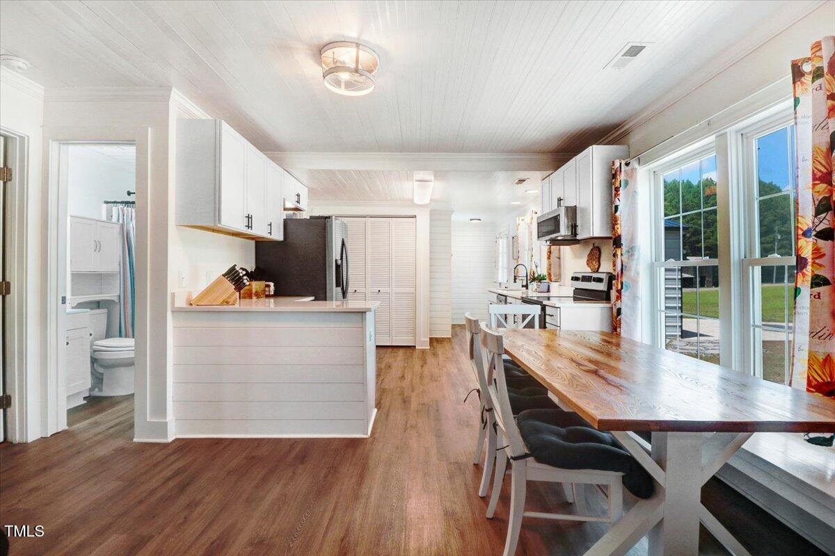 175 Debro Road Kenly, NC 27542 - Photo 8 of 30 a view of kitchen and dining room with wooden floor