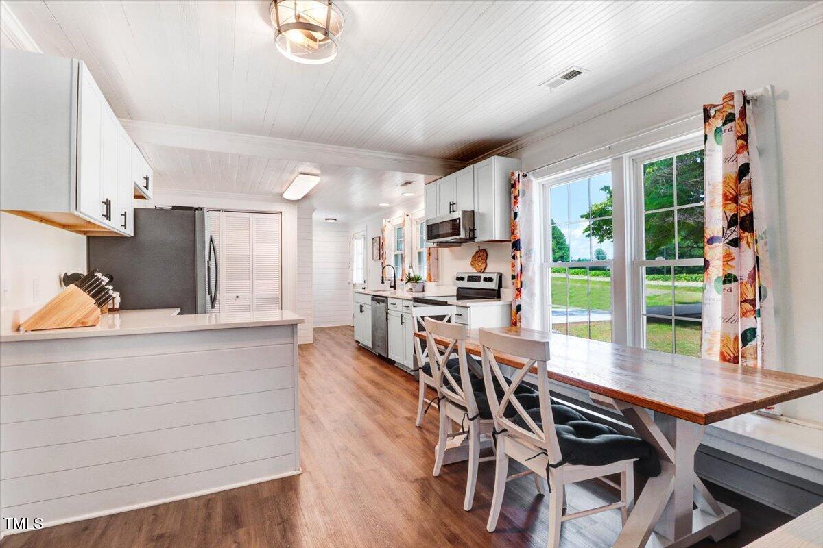175 Debro Road Kenly, NC 27542 - Photo 9 of 30 a view of a dining room with furniture window and wooden floor