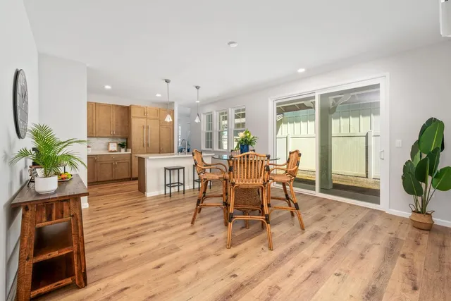 a dining room with furniture and wooden floor