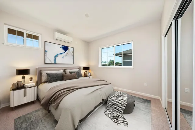 a bedroom with a bed and a painting on the wall