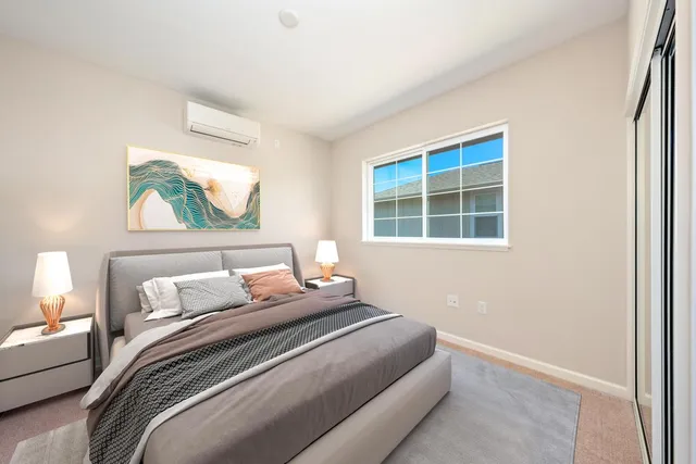 a bedroom with a bed and a window