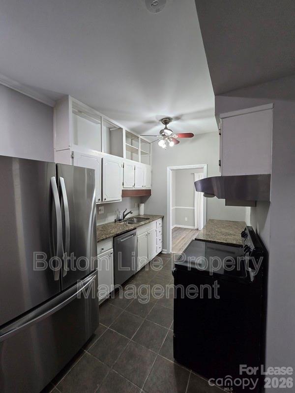 5949 Quail Hollow Road, Unit D Charlotte, NC 28210 - Photo 14 of 34 a kitchen with stainless steel appliances granite countertop a stove and a refrigerator