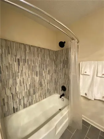 a bathroom with a tub and a shower curtain