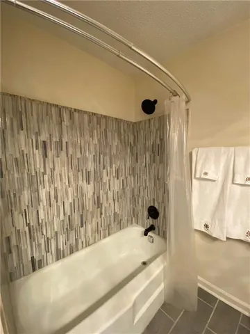 a bathroom with a tub and a shower curtain