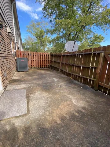 a view of a backyard with a small cabin and wooden fence