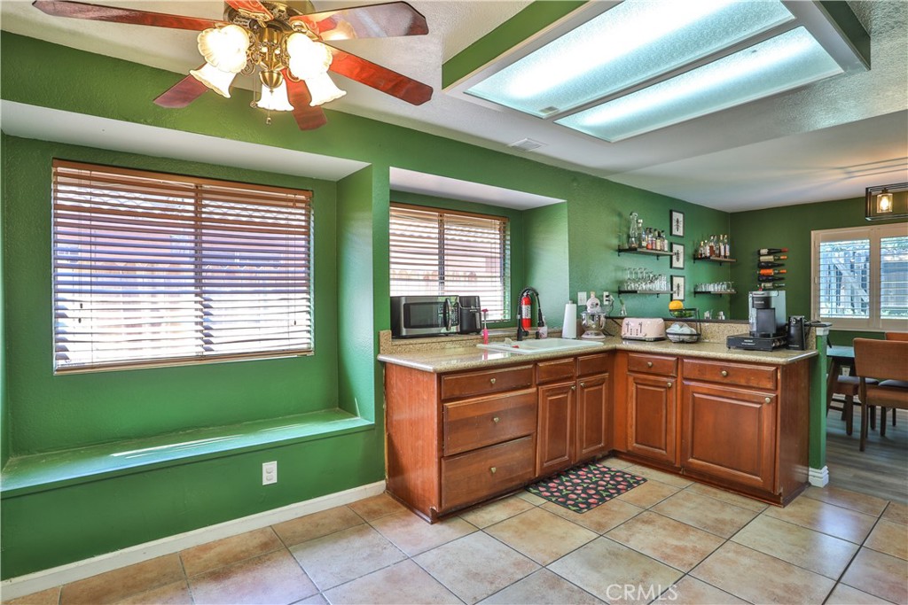 11369 Red Hill Road Moreno Valley, CA 92557 - Photo 13 of 41 a kitchen with a sink a counter top space and a window