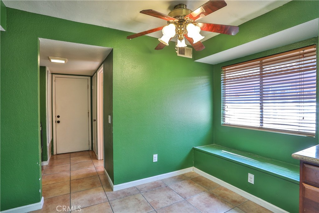 11369 Red Hill Road Moreno Valley, CA 92557 - Photo 14 of 41 a room with green walls and a ceiling fan