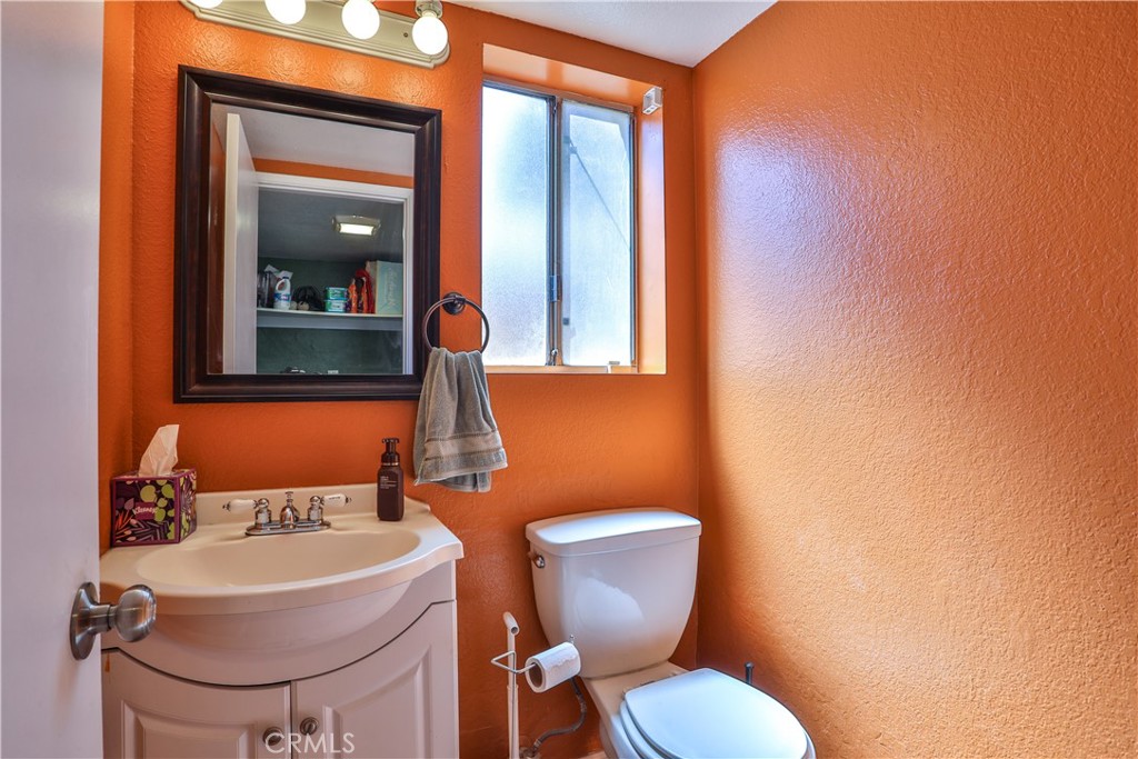 11369 Red Hill Road Moreno Valley, CA 92557 - Photo 16 of 41 a bathroom with a toilet a sink and mirror
