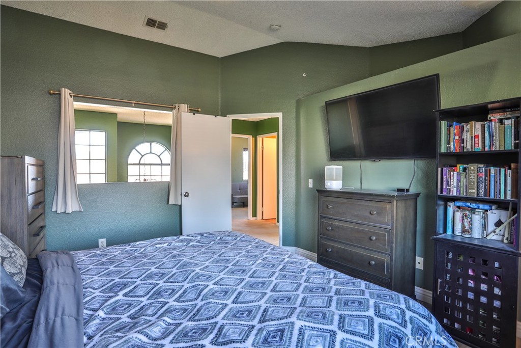 11369 Red Hill Road Moreno Valley, CA 92557 - Photo 19 of 41 a bedroom with a bed and a dresser in it