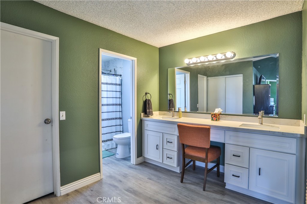 11369 Red Hill Road Moreno Valley, CA 92557 - Photo 23 of 41 a spacious bathroom with a double vanity sink and a mirror