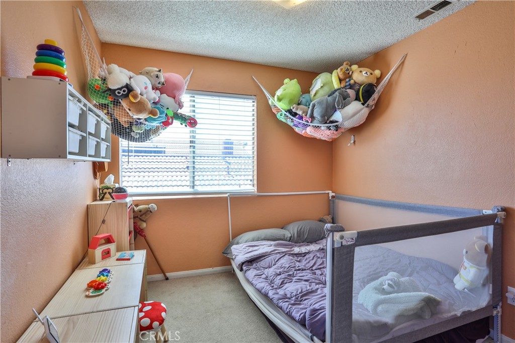 11369 Red Hill Road Moreno Valley, CA 92557 - Photo 26 of 41 a bedroom with a bed and a window