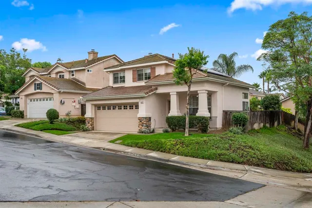 a front view of a house with a yard and a garage