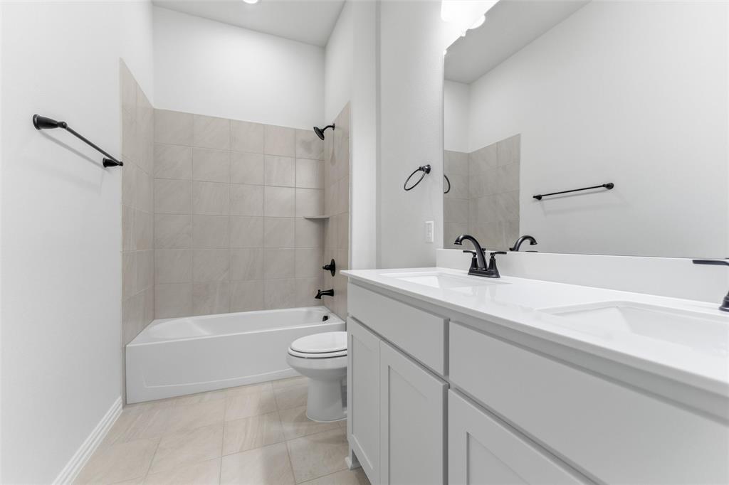 114 Brandywine Trail Rhome, TX 76078 - Photo 22 of 27 a bathroom with a sink a toilet and a bathtub