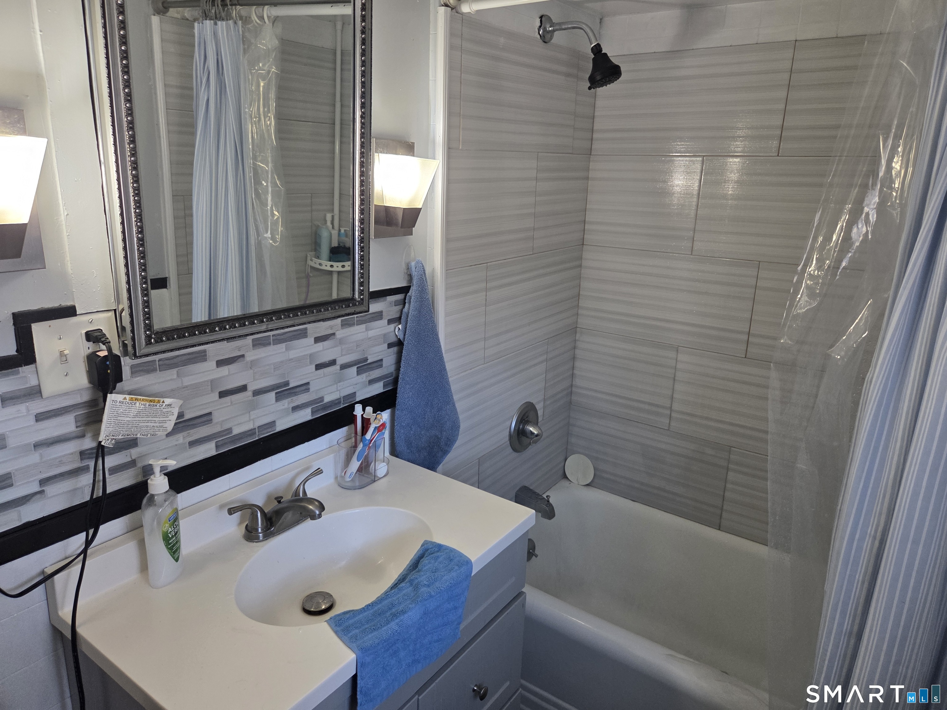 133 Maple Street Killingly, CT 06239 - Photo 11 of 12 a bathroom with a sink and a mirror