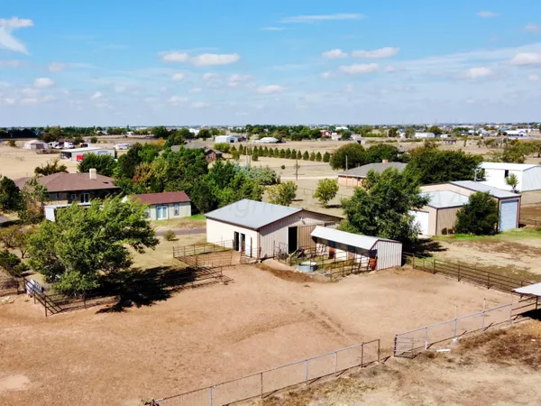 a view of hallway with furniture and a chandelier