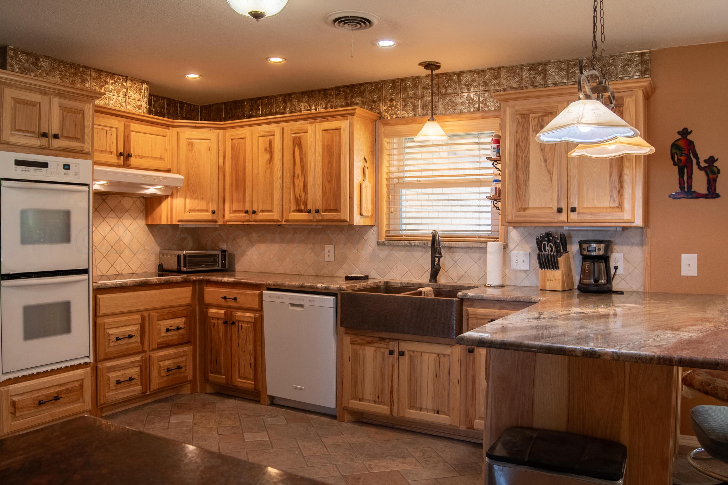 14653 Halsey Trail Amarillo, TX 79118 - Photo 28 of 66 a kitchen with stainless steel appliances granite countertop a sink a stove and cabinets