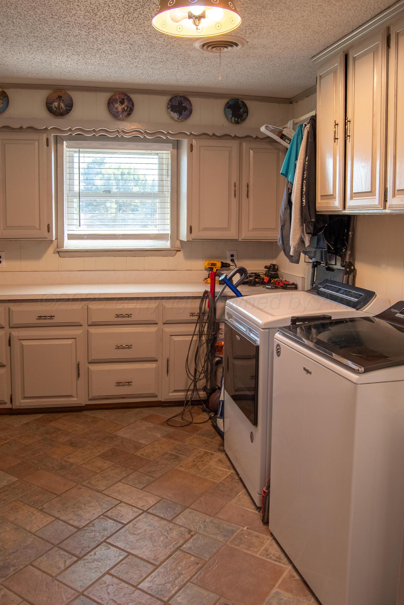 14653 Halsey Trail Amarillo, TX 79118 - Photo 46 of 66 a utility room with cabinets washer and dryer