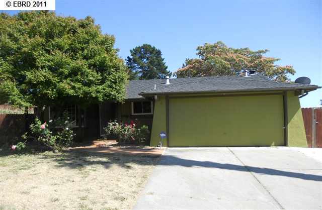 860 Coral Drive Rodeo, CA 94572 - Photo 1 of 1 a front view of a house with a yard