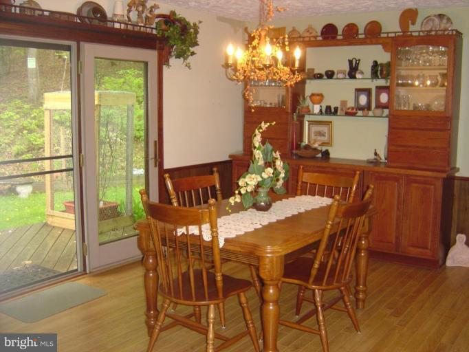 138 Windy Pines Road Front Royal, VA 22630 - Photo 11 of 17 a view of a dining room with furniture a chandelier and wooden floor