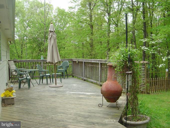 138 Windy Pines Road Front Royal, VA 22630 - Photo 17 of 17 a backyard of a house with table and chairs