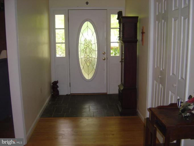 138 Windy Pines Road Front Royal, VA 22630 - Photo 3 of 17 an empty room with wooden floor mirror and windows