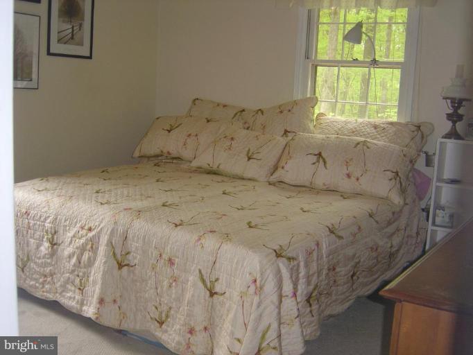 138 Windy Pines Road Front Royal, VA 22630 - Photo 6 of 17 a bed sitting in a bedroom next to a window