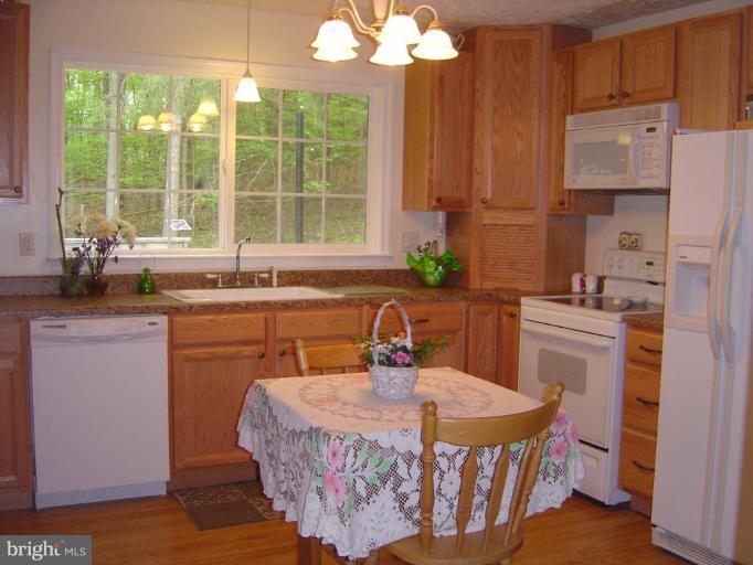 138 Windy Pines Road Front Royal, VA 22630 - Photo 9 of 17 a kitchen with a sink stove and cabinets