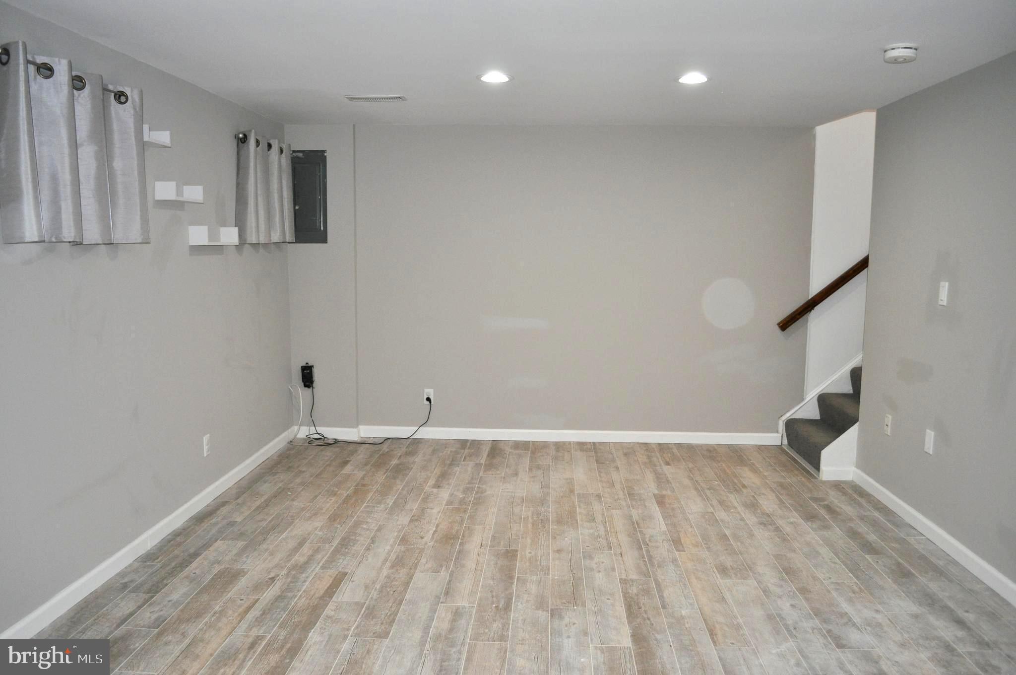 9110 Tumbleweed Run, Unit E Laurel, MD 20723 - Photo 19 of 39 Lower Level Family Room with updated tile floor