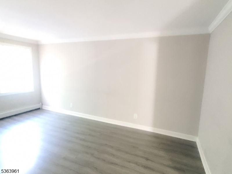 935 East Front Street Plainfield, NJ 07062 - Photo 11 of 25 a view of an empty room and wooden floor