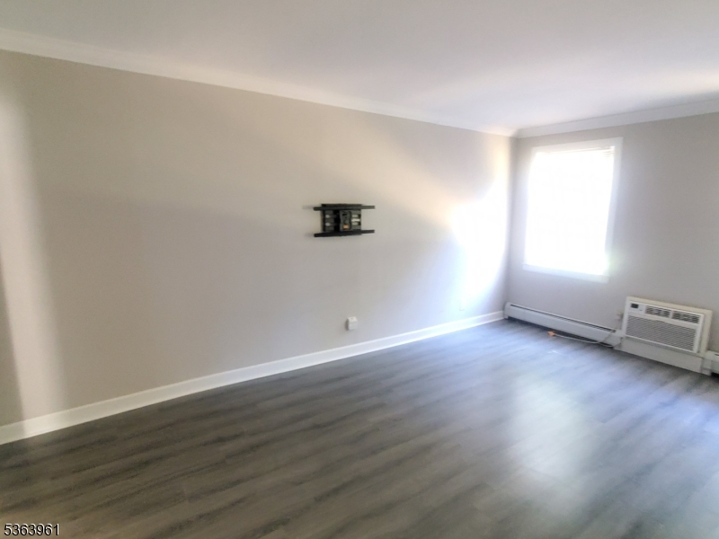 935 East Front Street Plainfield, NJ 07062 - Photo 10 of 25 an empty room with wooden floor and windows