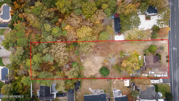 an aerial view of a houses with yard