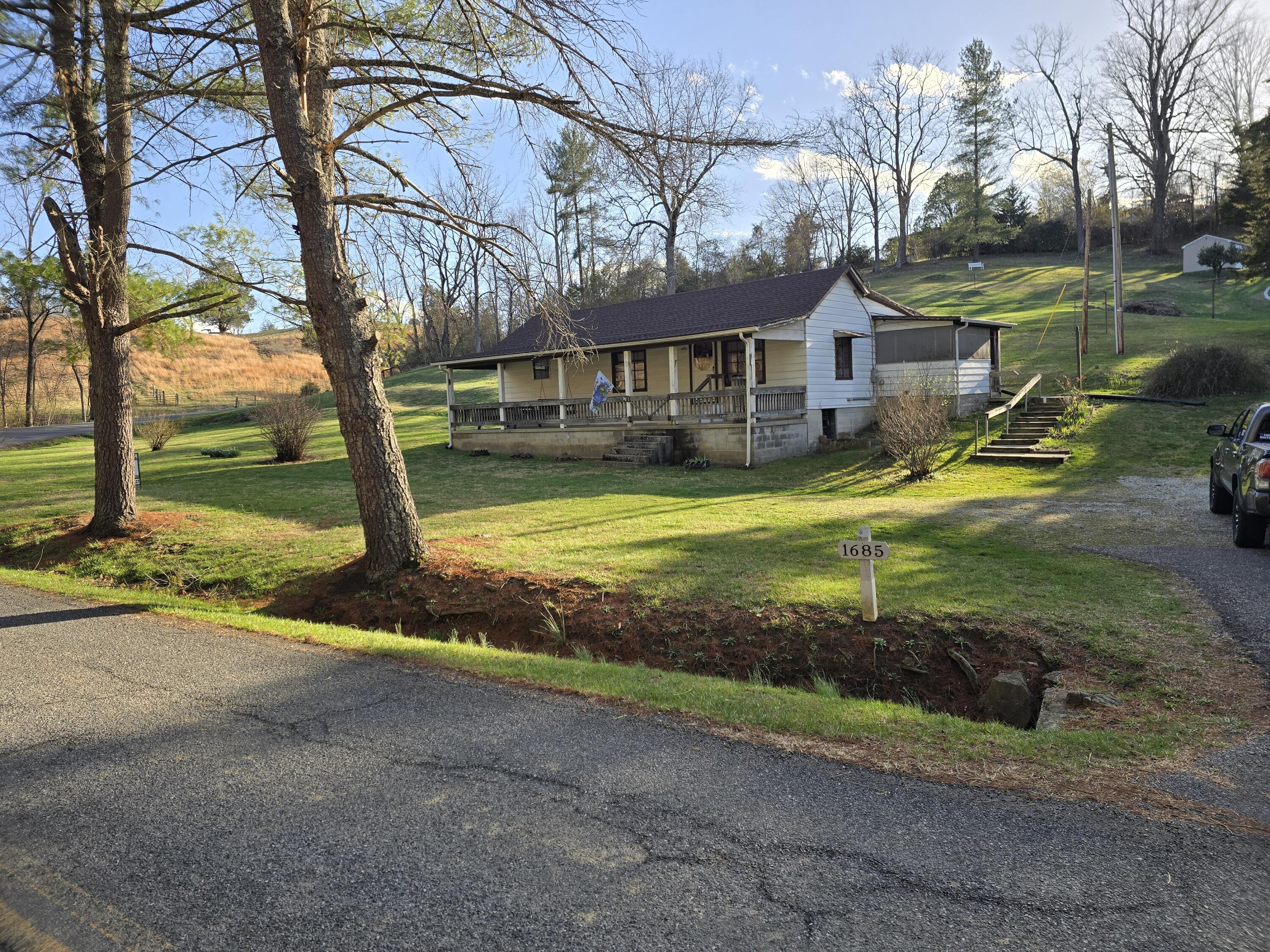 a view of a house with swimming pool and a yard