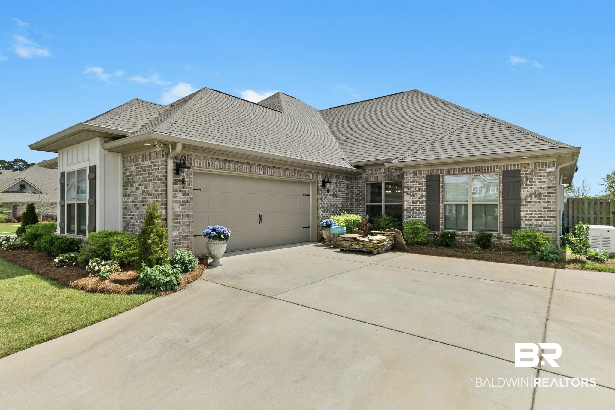 291 Hemlock Drive Fairhope, AL 36532 - Photo 65 of 65 View of front of property featuring brick siding, roof with shingles, driveway, and a garage