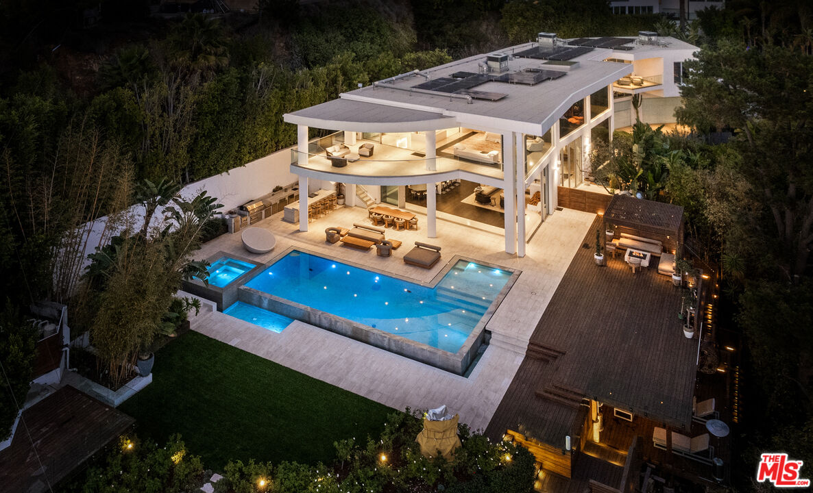 an aerial view of a house with a yard basket ball court and outdoor seating