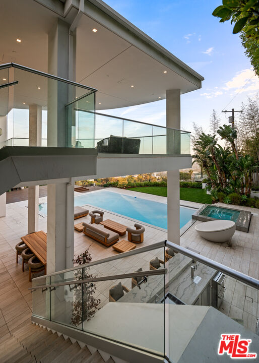 1609 Magnetic Terrace Los Angeles, CA 90069 - Photo 13 of 24 a kitchen with stainless steel appliances kitchen island granite countertop a sink and white cabinets