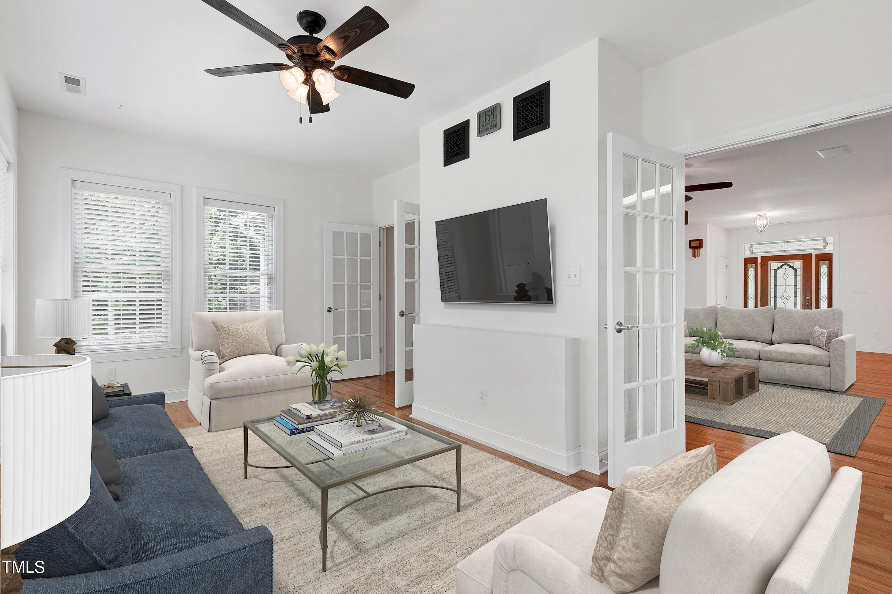 644 Uwharrie Ridge Road Chapel Hill, NC 27516 - Photo 21 of 43 a living room with furniture a flat screen tv and a large window