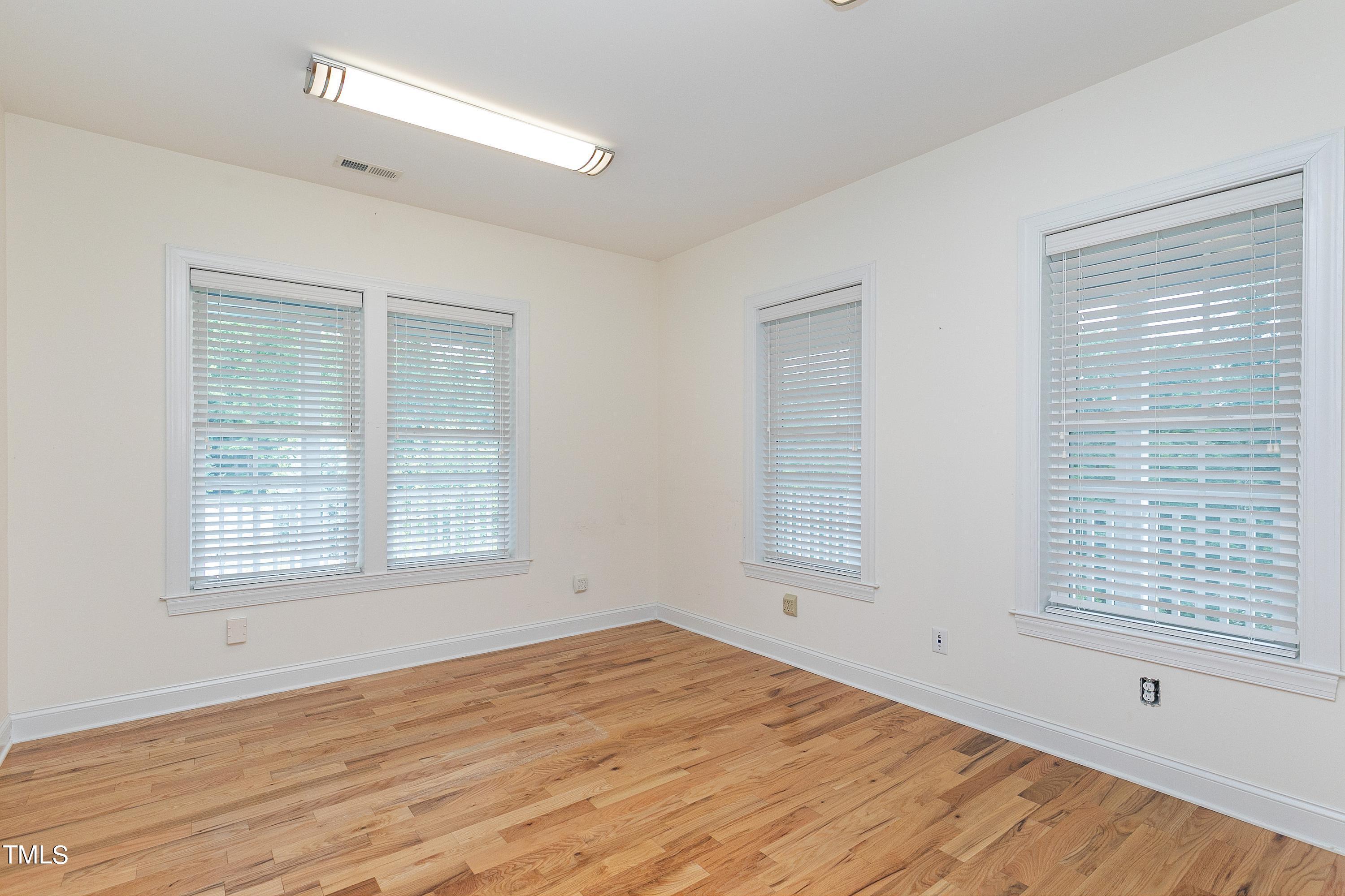 644 Uwharrie Ridge Road Chapel Hill, NC 27516 - Photo 28 of 43 a view of empty room with wooden floor and fan