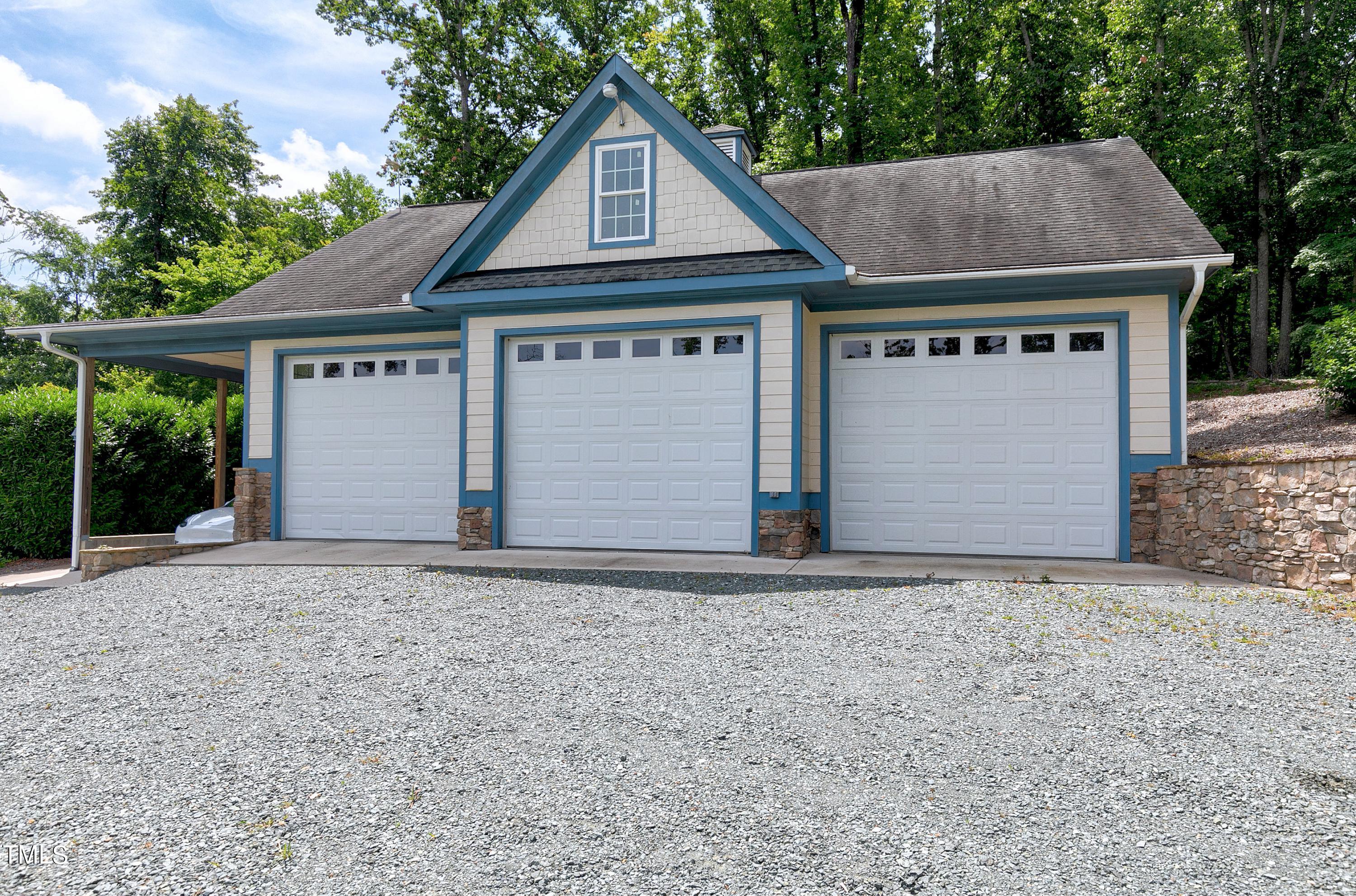 644 Uwharrie Ridge Road Chapel Hill, NC 27516 - Photo 39 of 43 a front view of a house with a yard and garage