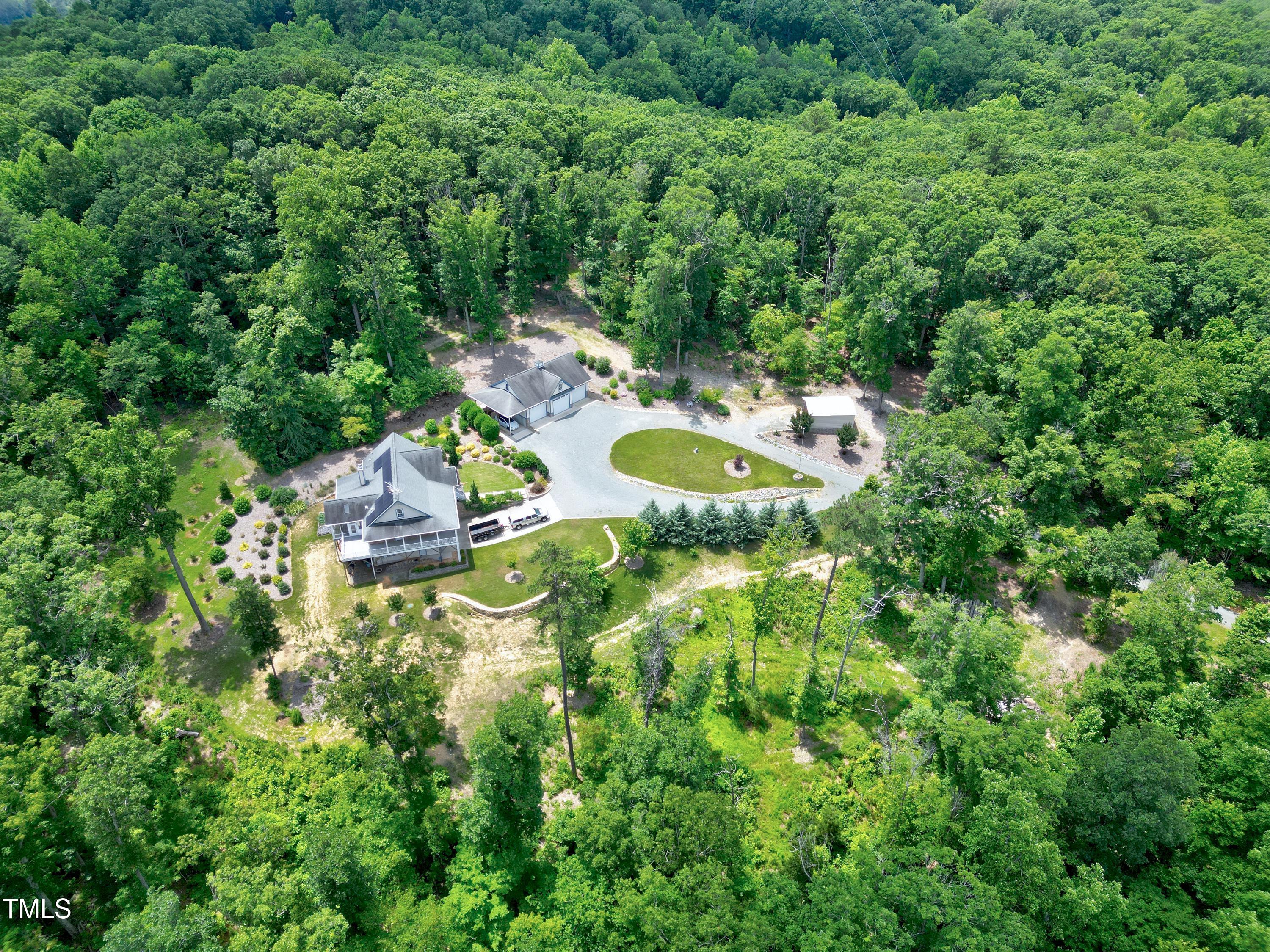 644 Uwharrie Ridge Road Chapel Hill, NC 27516 - Photo 4 of 43 a backyard of a house with a table and chairs