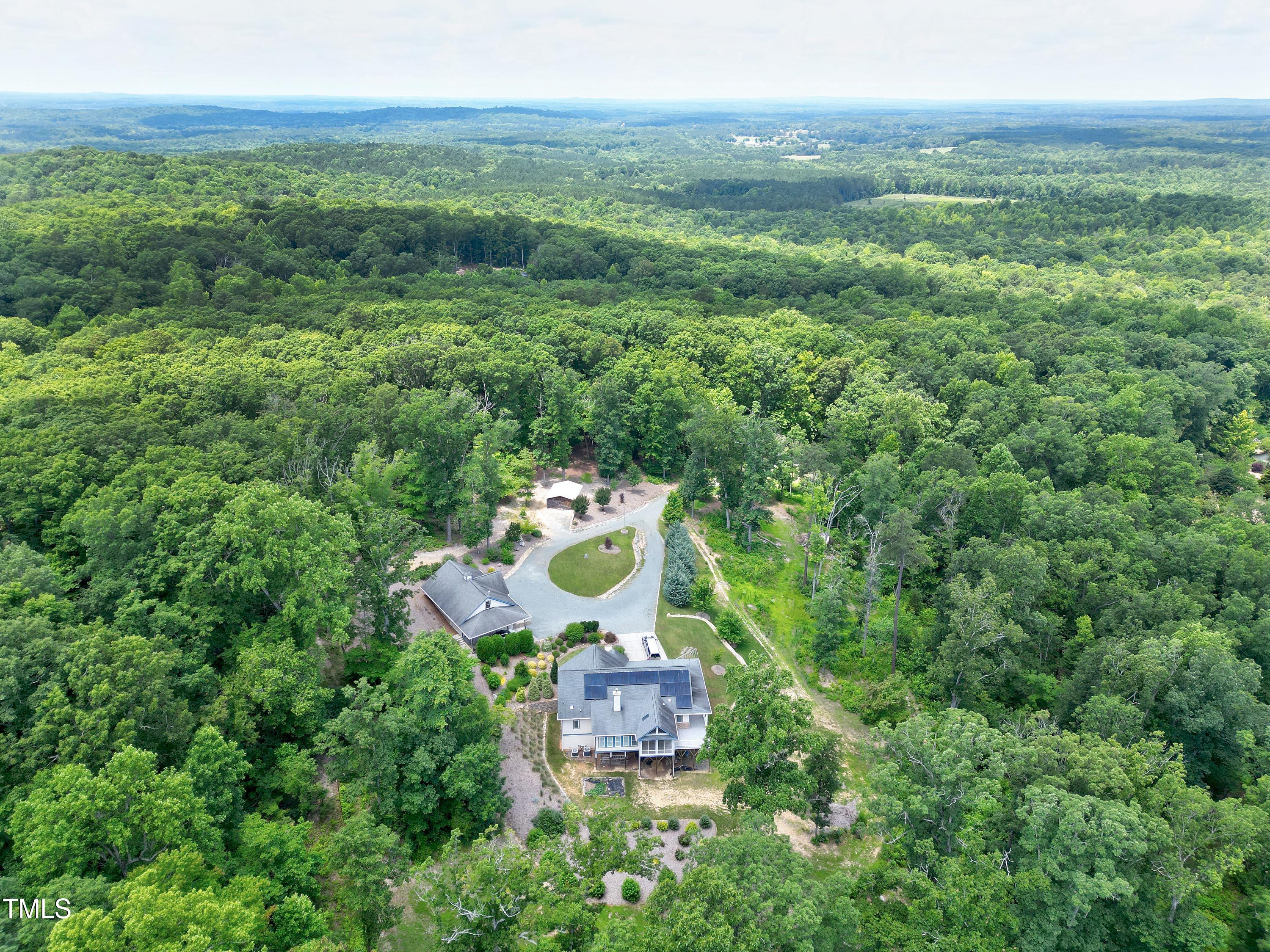 644 Uwharrie Ridge Road Chapel Hill, NC 27516 - Photo 5 of 43 a view of a house with a yard and large trees