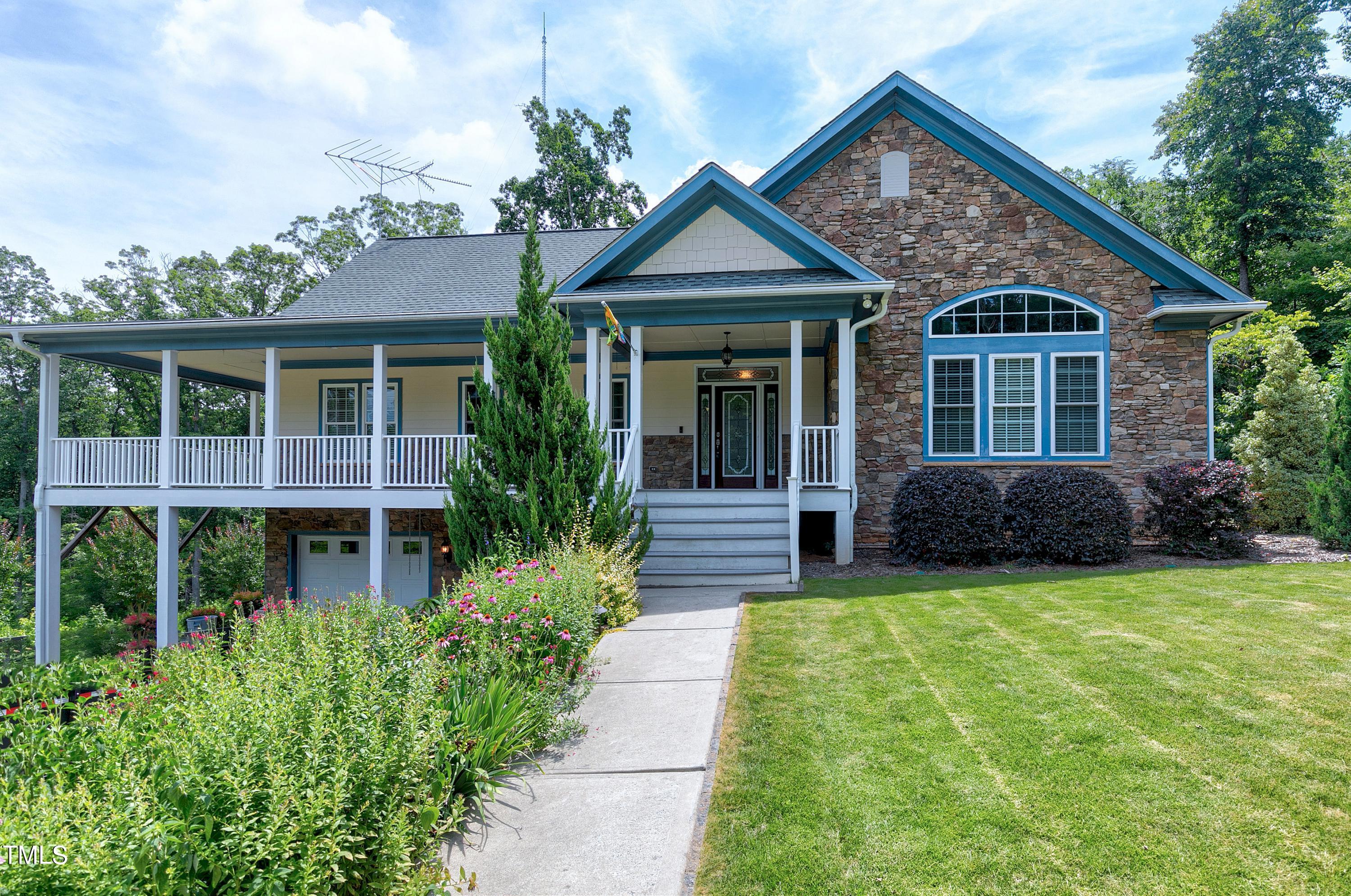 644 Uwharrie Ridge Road Chapel Hill, NC 27516 - Photo 7 of 43 a view of a house with a small yard and potted plants