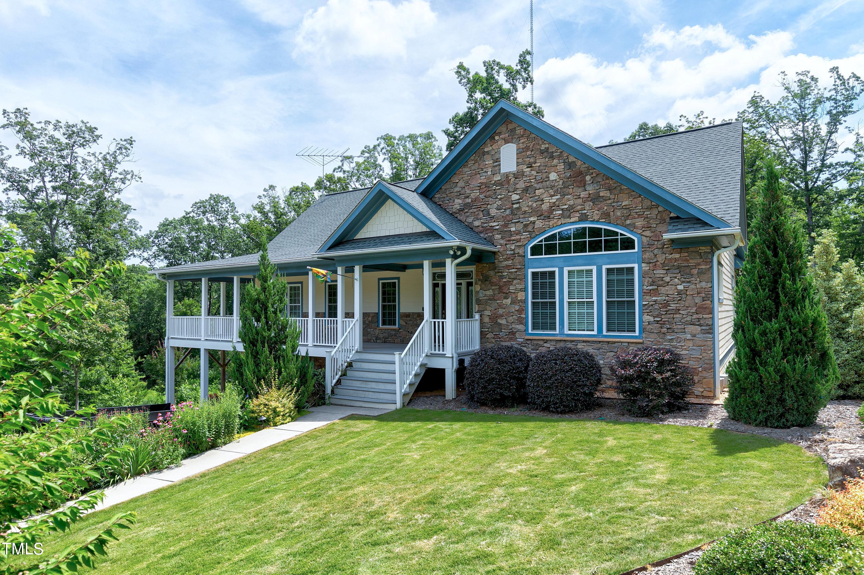 644 Uwharrie Ridge Road Chapel Hill, NC 27516 - Photo 8 of 43 a front view of a house with a yard