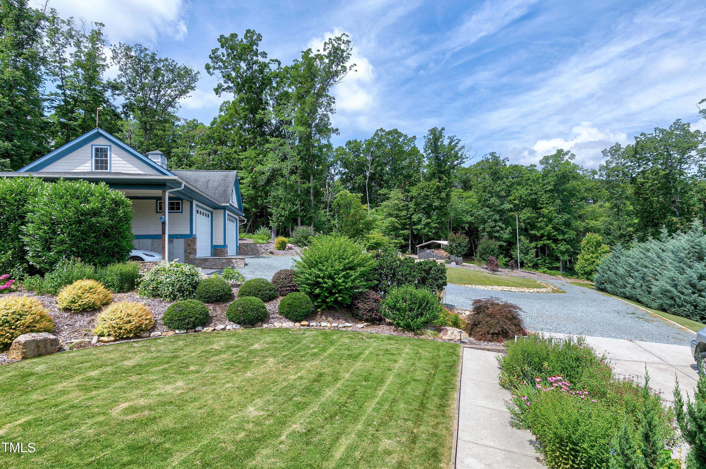 644 Uwharrie Ridge Road Chapel Hill, NC 27516 - Photo 9 of 43 a front view of a house with garden