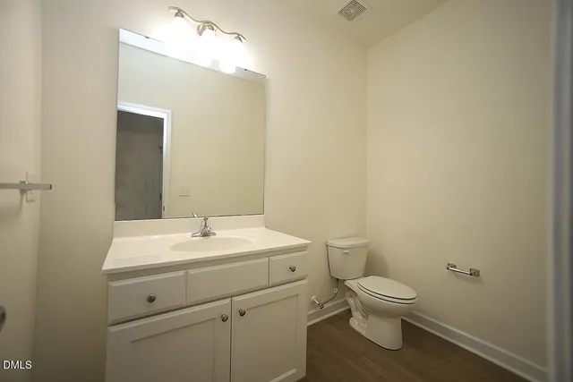 a white toilet sitting next to a bathroom sink