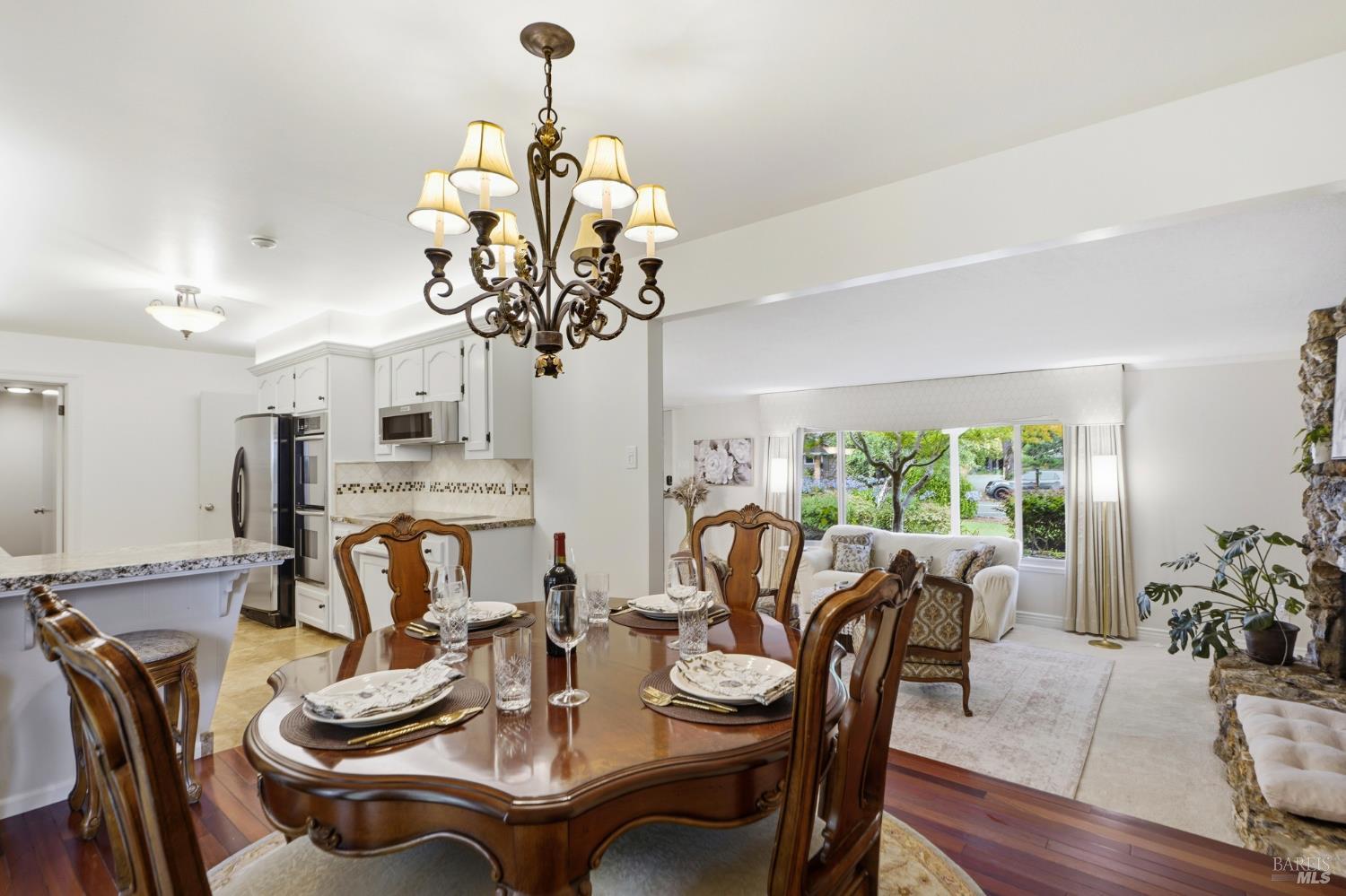 373 Piezzi Road Santa Rosa, CA 95401 - Photo 19 of 55 a dining room with furniture a large window and wooden floor
