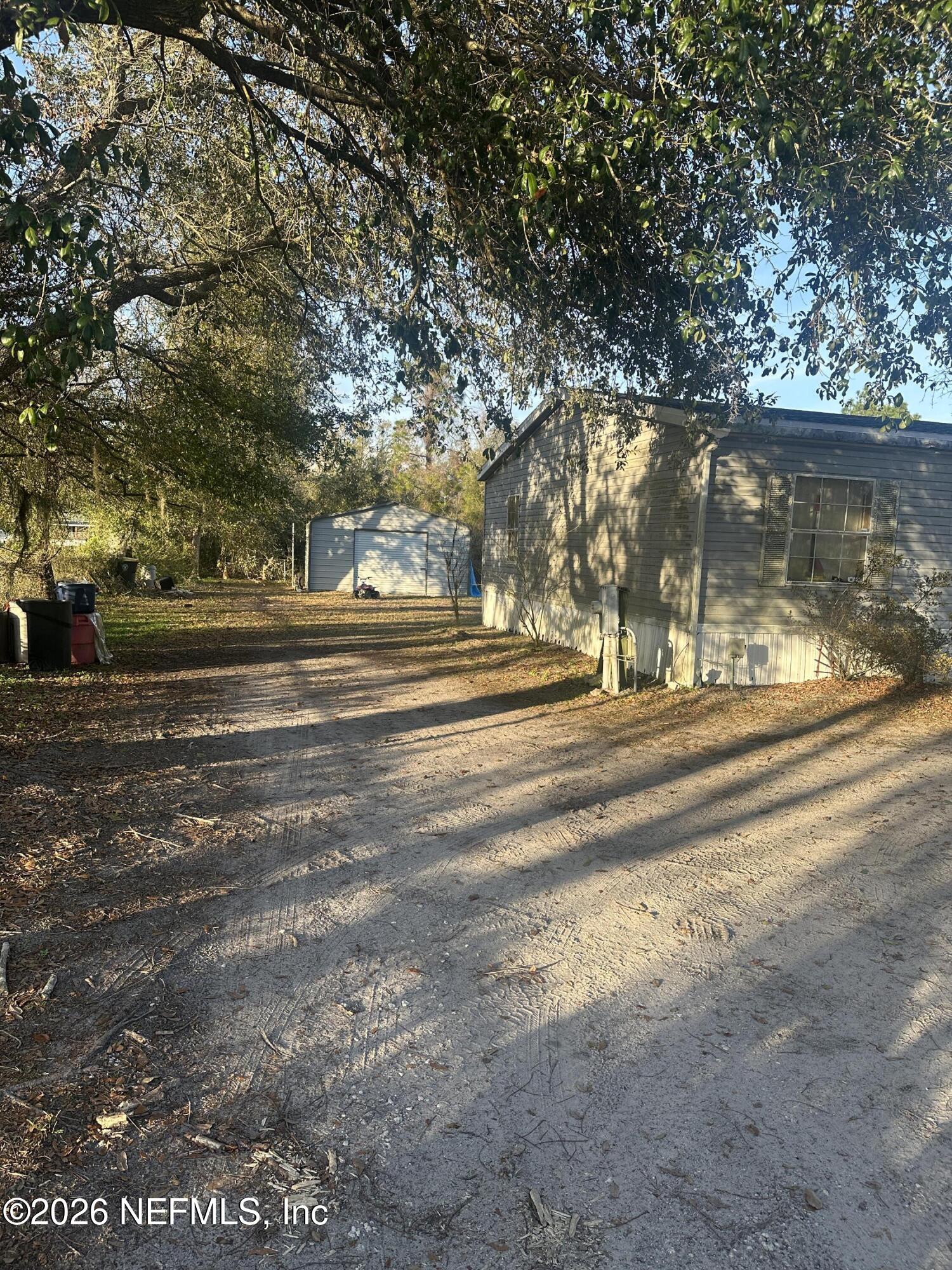 10269 Grayson Street Jacksonville, FL 32220 - Photo 5 of 9 a view of a yard with large trees